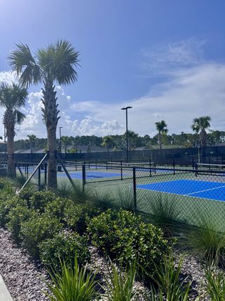 Community Amenities Scenic tennis courts with lush landscaping and palm trees in Edenbrooke at Hyland Trail by Lennar (Green Cove Springs, FL).