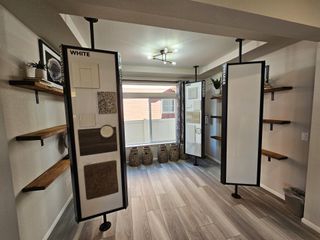 A modern design studio with sample boards, sleek wooden shelves, and soft natural lighting highlighting the decor.