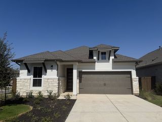 A charming stone accent home with a spacious garage in Arbor Collection at Bryson by Tri Pointe Homes (Leander, TX).