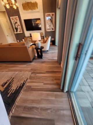 A modern living area with wood accents, sleek decor, and a warm ambiance, seamlessly flowing into an outdoor retreat.