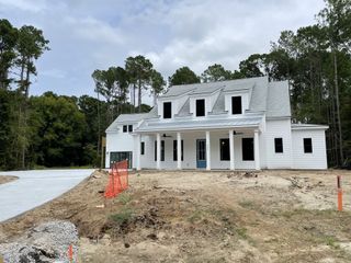 A modern white home amid trees in Pamlico Terrace by DRB Homes, Awendaw, SC.