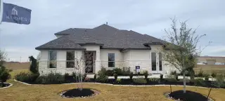 A modern stone-accented home with manicured landscaping in Everly Estates by M/I Homes (San Antonio, TX).
