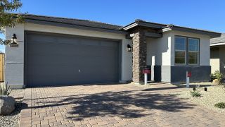 Street view A modern grey garage and stone feature adorn this home in Estrella: Acacia Foothills II by Beazer Homes (Goodyear, AZ).