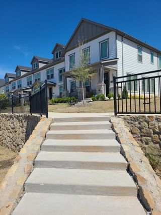 Charming townhomes with gabled roofs in Village on Main Street by Normandy Homes in Frisco, TX.