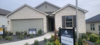 Charming light stone home with landscaped yard at Hunters Ranch by M/I Homes in San Antonio, TX.