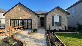 A charming home with a well-designed facade and manicured landscaping in the Preserve at Culebra by KB Home (San Antonio, TX).