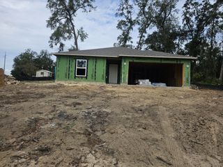 Under-construction home with green sheathing in Inverness by Maronda Homes, set in a wooded lot in Inverness, FL.