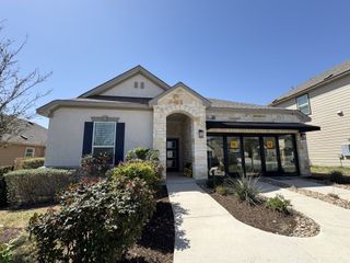 A charming stone-accented home with manicured landscaping in EastVillage - Classic Collection by KB Home (Manor, TX).