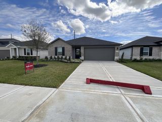 Street view A modern brick home with lush landscaping in Sweetgrass Village: Landmark Collection by Beazer Homes (Crosby, TX).