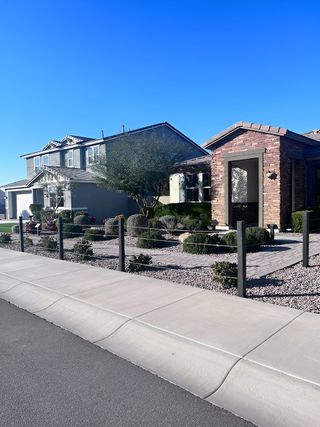 A beautiful brick and stucco home with desert landscaping in Cordillera by KB Home (Gilbert, AZ).