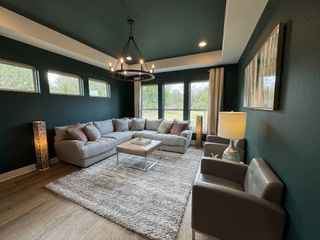 A modern living room with wood beams, built-in cabinets, and sliding doors.