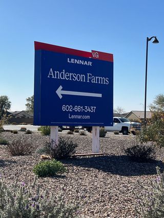A welcoming sign directs to Anderson Farms: Premier by Lennar in the serene landscape of Maricopa, AZ.