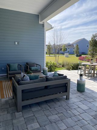 A shaded patio with comfortable seating, a modern fire pit, and serene views, offering a perfect spot to unwind.