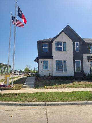 Street view A modern two-story home with sleek design in Chelsea Commons by Cadence Homes (Allen, TX), featuring a white brick facade.