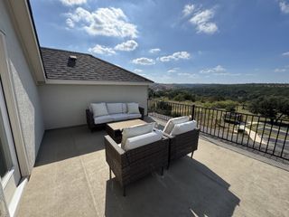A spacious outdoor patio with comfortable seating, offering panoramic views of the surrounding landscape in Sweetwater by Pulte Homes (San Antonio, TX).