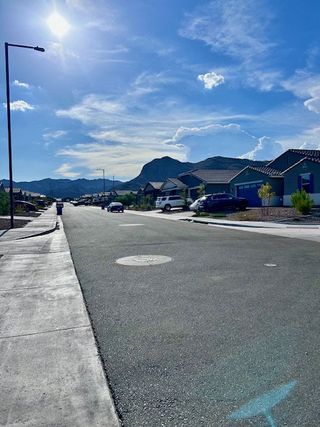 Quiet suburban street with mountain views in Canyon Views by Starlight Homes (Litchfield Park, AZ).