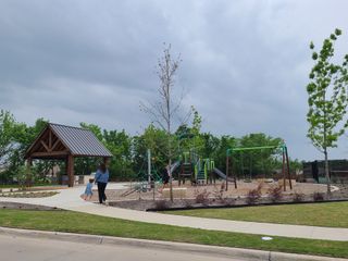 A family-friendly park with a pavilion and playground in Meadow Park by Ashton Woods (Melissa, TX).