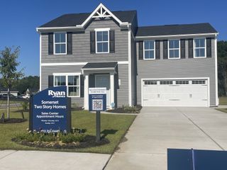 A charming gray two-story house with a manicured lawn in Somerset Two-Story Homes by Ryan Homes (Santee, SC).