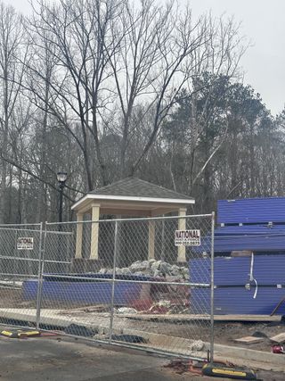 A construction site with a pavilion and trees in Echo Park by UnionMain Homes, located in Suwanee, GA.