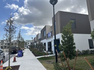 Street view Modern townhomes with sleek design and landscaped path in On Grandville by Onx Homes (Homestead, FL).