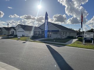 A beautiful modern home with a sleek facade and landscaped surroundings in Autumn Glen by D.R. Horton (Belleview, FL).