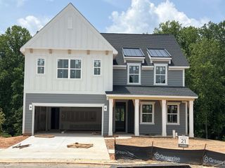 Street view A charming two-story home with a modern design and spacious porch in Eckley by Tri Pointe Homes (Mooresville, NC).