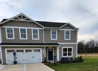 A charming beige two-story home with modern design in Williams Run by Ryan Homes (Bailey, NC).
