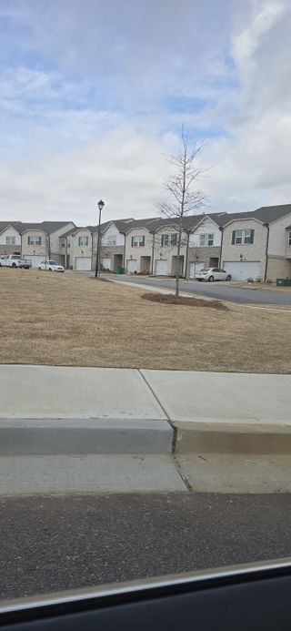A row of modern townhomes with garages in Sweetwater Green - Club Series by Meritage Homes (Lawrenceville, GA).