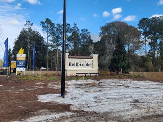 Entrance to Bellbrooke, a serene community by Dream Finders Homes in Jacksonville, FL, surrounded by lush greenery.