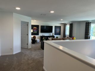 A cozy living area featuring plush seating, modern decor, and playful wall art, ideal for relaxation and entertainment.