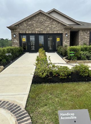 A welcoming brick home with manicured landscaping in Sagecrest Preserve by KB Home, Conroe, TX.