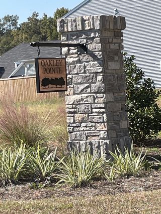 Charming stone entrance at Oakley Pointe by Eastwood Homes, nestled in scenic Moncks Corner, SC.