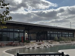 Community Amenities A modern community center with a sleek pool in Whisper Valley by Terrata Homes (Manor, TX).