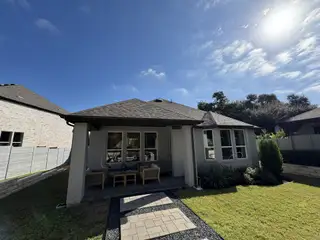 A charming home with a cozy patio and manicured lawn in Wolf Ranch: 51ft. lots by Highland Homes (Georgetown, TX).