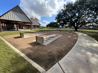 A modern pavilion with a metal roof and picnic tables, perfect for gatherings and outdoor fun.