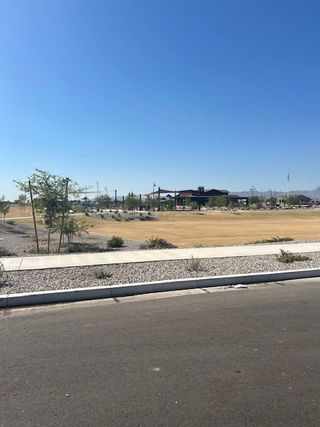A scenic view with open landscapes and a modern community center in Silva Farms by Meritage Homes (Goodyear, AZ).