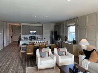 An elegant open-plan living area with cozy seating, sleek kitchen, and stylish dining space.