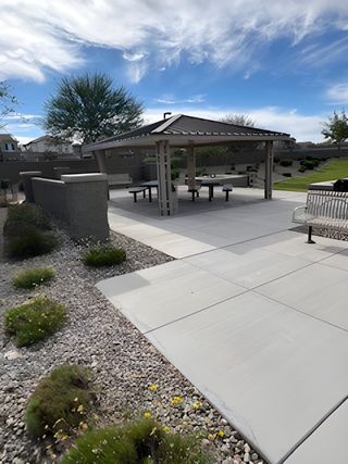 Community Amenities A modern outdoor pavilion with picnic tables and landscaped grounds in Redwood Valley at Escalante by Fulton Homes (Surprise, AZ).