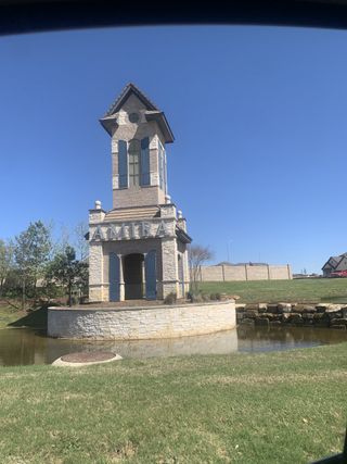 A charming stone entrance tower with water feature welcomes you to Amira 50' by Perry Homes in Tomball, TX.