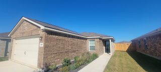 A charming brick home with tidy landscaping in Preserve at Medina by LGI Homes, San Antonio, TX.