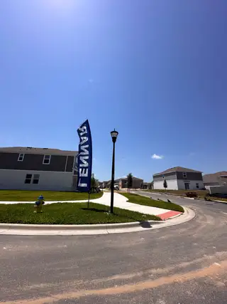 A modern community with spacious homes and well-maintained lawns at Wellness Ridge: Manor Collection by Lennar (Clermont, FL).