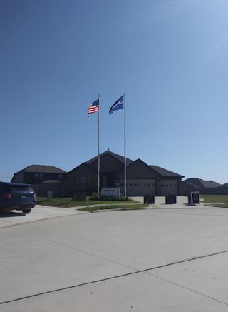A stunning Lennar model home in Samara (League City, TX) with a spacious driveway, modern design, and beautifully maintained landscaping.