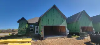 A modern home under construction in VIDA Townhomes by Sitterle Homes, San Antonio, TX, showcasing energy-efficient design.