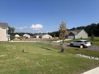 Street view Charming homes with manicured lawns and a vibrant community feel in Saddlebrook by Smith Douglas Homes (Sherrills Ford, NC).