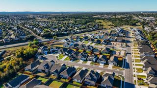 Aerial view of a vibrant neighborhood in Brooks Ranch by D.R. Horton, showcasing modern homes in Kyle, TX.