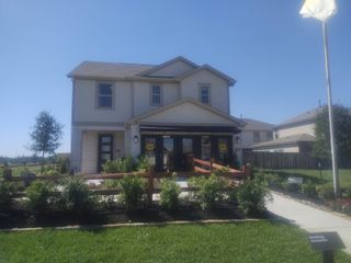 A charming two-story home with a manicured lawn in Glendale Lakes North by KB Home (Arcola, TX).