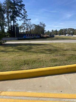 Entrance to ARTAVIA® - 65' Art Collection by Westin Homes in Conroe, TX, with landscaped surroundings and a welcoming sign.