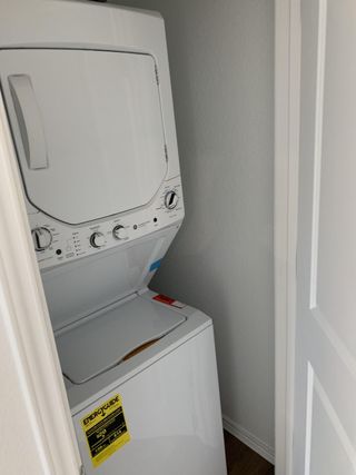 Model Home A space-efficient laundry area with a stackable washer and dryer tucked neatly behind a closet door.