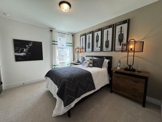 A modern bedroom with music-themed decor, featuring a cozy bed, unique lighting, and stylish wall art.