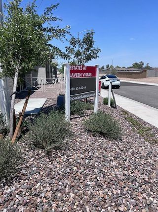 A welcoming landscape in Estates at Laveen Vistas by Richmond American Homes, featuring a well-kept street in Laveen, AZ.